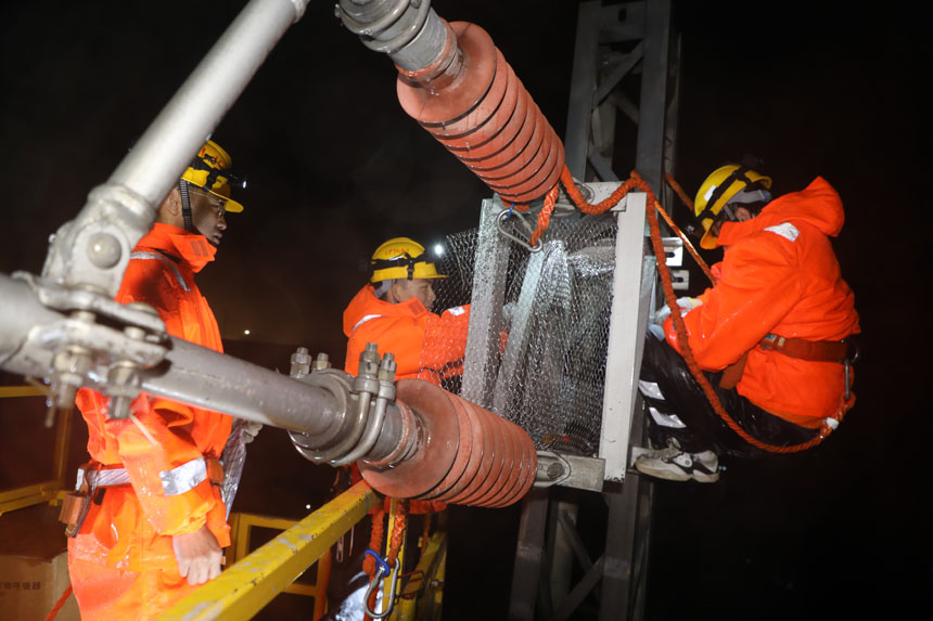 為了防止小鳥再來筑巢，工友們在接觸網設備上安裝防鳥網。李金明攝
