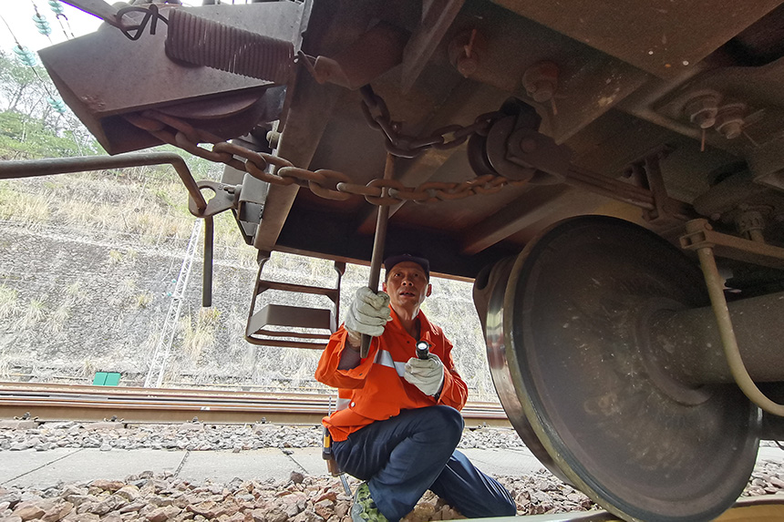 檢車員周志榮正在對人力制動機鏈進行檢查。王文奇攝