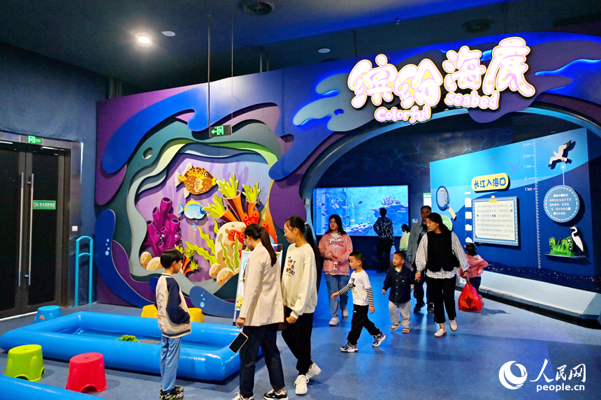 九江市湖口縣江豚灣的長江鄱陽湖水生生物保護基地，許多游客在水族館觀賞水生物。人民網 朱海鵬攝