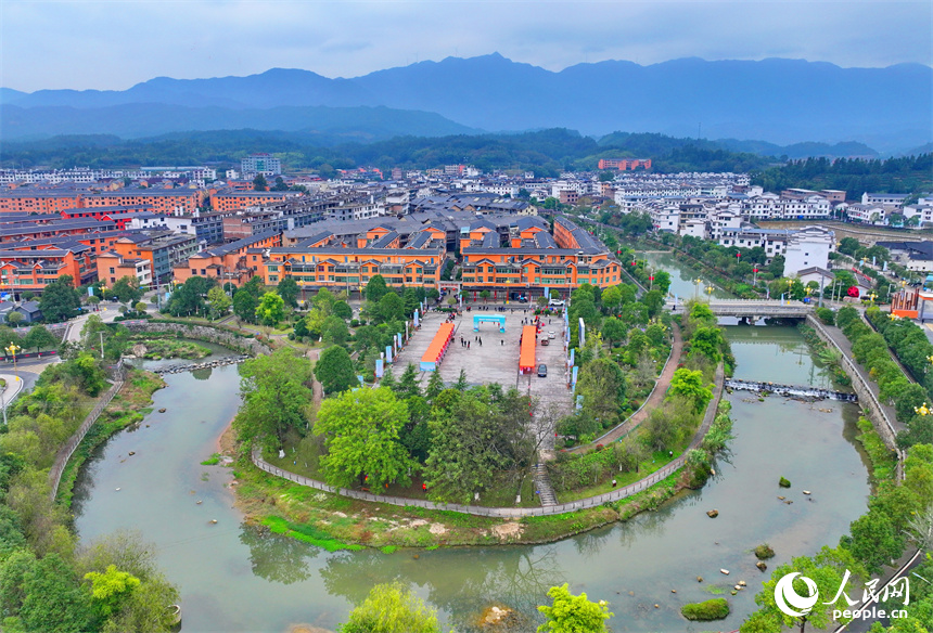 贛州市寧都縣小布鎮，鄉村公路旁的農家房屋整齊排列，與蜿蜒河流、連綿山巒相映成景。人民網 朱海鵬攝