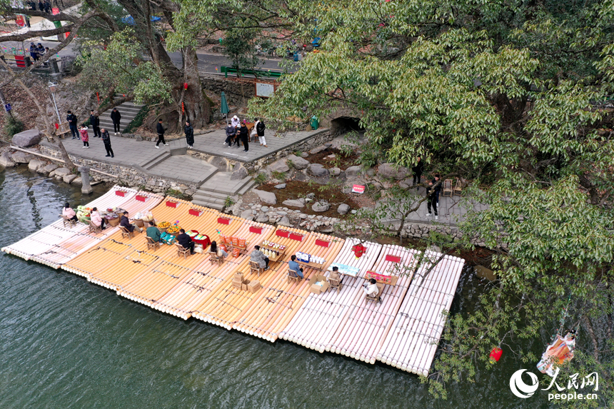 港背村的村民在河邊竹排上售賣山村土特產。人民網記者 時雨攝
