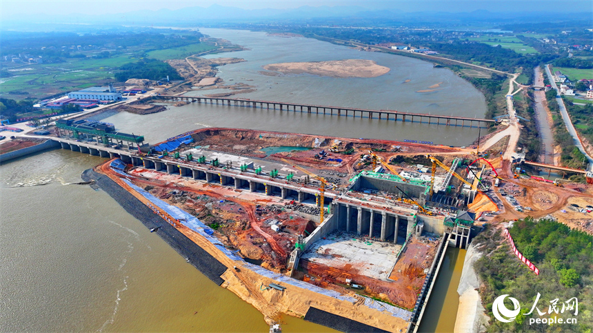 撫州市金溪縣滸灣鎮，疏山水利樞紐工程施工現場塔吊林立，工人在建設樞紐水閘和大壩。人民網 朱海鵬攝