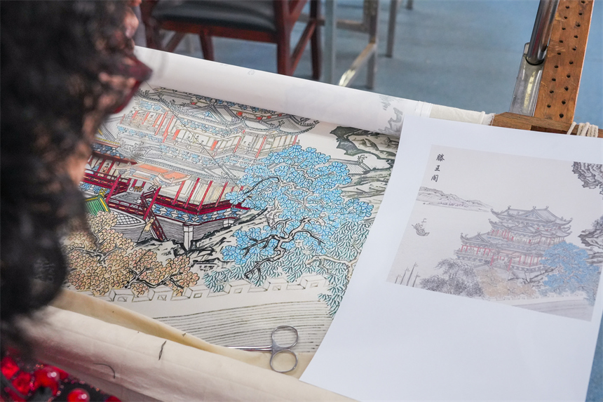余正連正在創作的刺繡作品《滕王閣》。人民網 孔文進攝