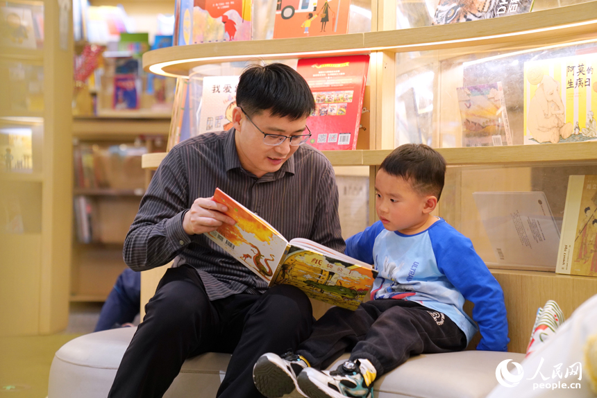 撫州市臨川區“拾光薈”購物廣場內的湯顯祖書店，小讀者被繪本故事吸引。人民網 朱海鵬攝