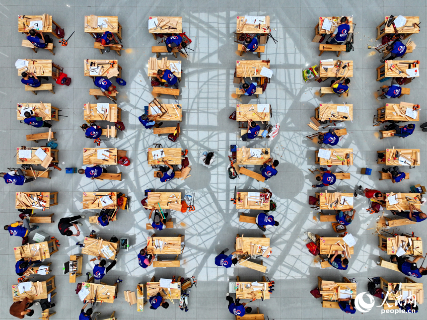 贛州市南康區家居小鎮博覽中心，幾十名木匠工人在手工木工（木制家具工）職業技能競賽決賽中制作家具。人民網 朱海鵬攝
