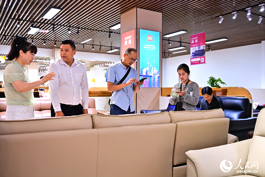 贛州市南康區的米蘭國際家居城，消費者在展廳咨詢補貼政策選購家具產品。人民網 朱海鵬攝