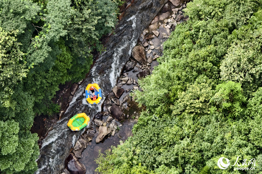 在江西省資溪縣大覺山的漂流水道上，游客們正乘著小艇順流而下，享受山泉水帶來的清涼。人民網記者 時雨攝