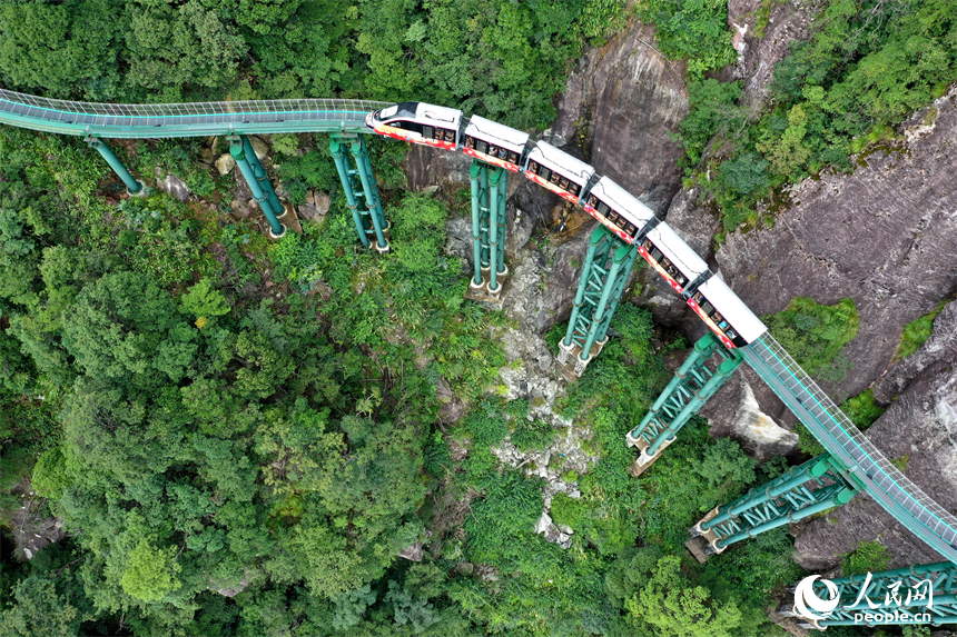 資溪縣大覺山景區，懸崖動車在綠山間穿行，游客們感受“云端飛馳”的刺激與震撼。人民網記者 時雨攝