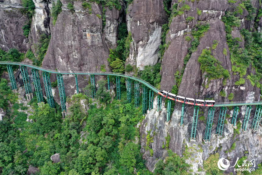 資溪縣大覺山景區，懸崖動車在綠山間穿行，游客們感受“云端飛馳”的刺激與震撼。人民網記者 時雨攝