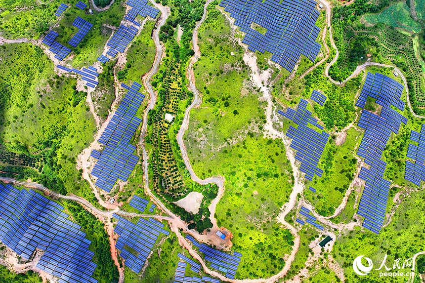 贛州市石城縣琴江鎮的一處光伏發電基地，鱗次櫛比的太陽能光伏板與青山綠樹、村莊田園相映襯，大地如同披上藍色“外衣”。人民網 朱海鵬攝