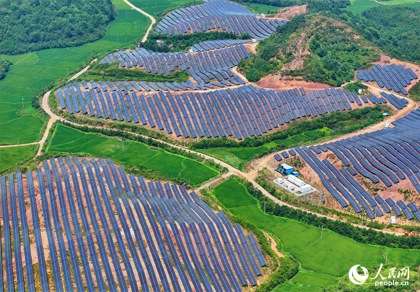 德興市香屯街道蘭村村20MW集中式光伏電站，荒山坡上的一排排光伏發電板熠熠生輝，源源不斷地輸出綠色電能。人民網 朱海鵬攝